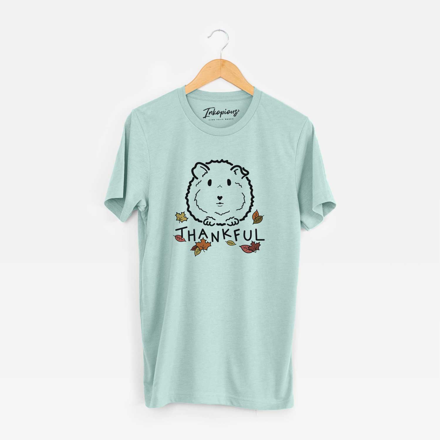 Minimalist line drawing of Duke the Guinea Pig with 'Thankful' lettering on a Heather Sage Unisex crewneck