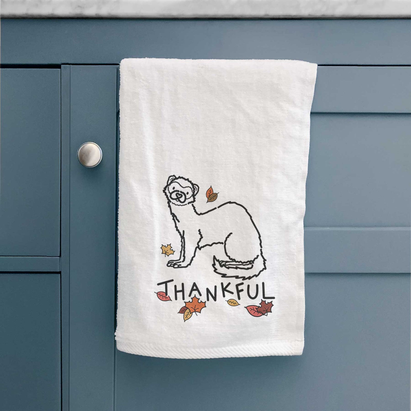 Minimalist line drawing of Fern the Ferret with 'Thankful' lettering on a decorative hand towel