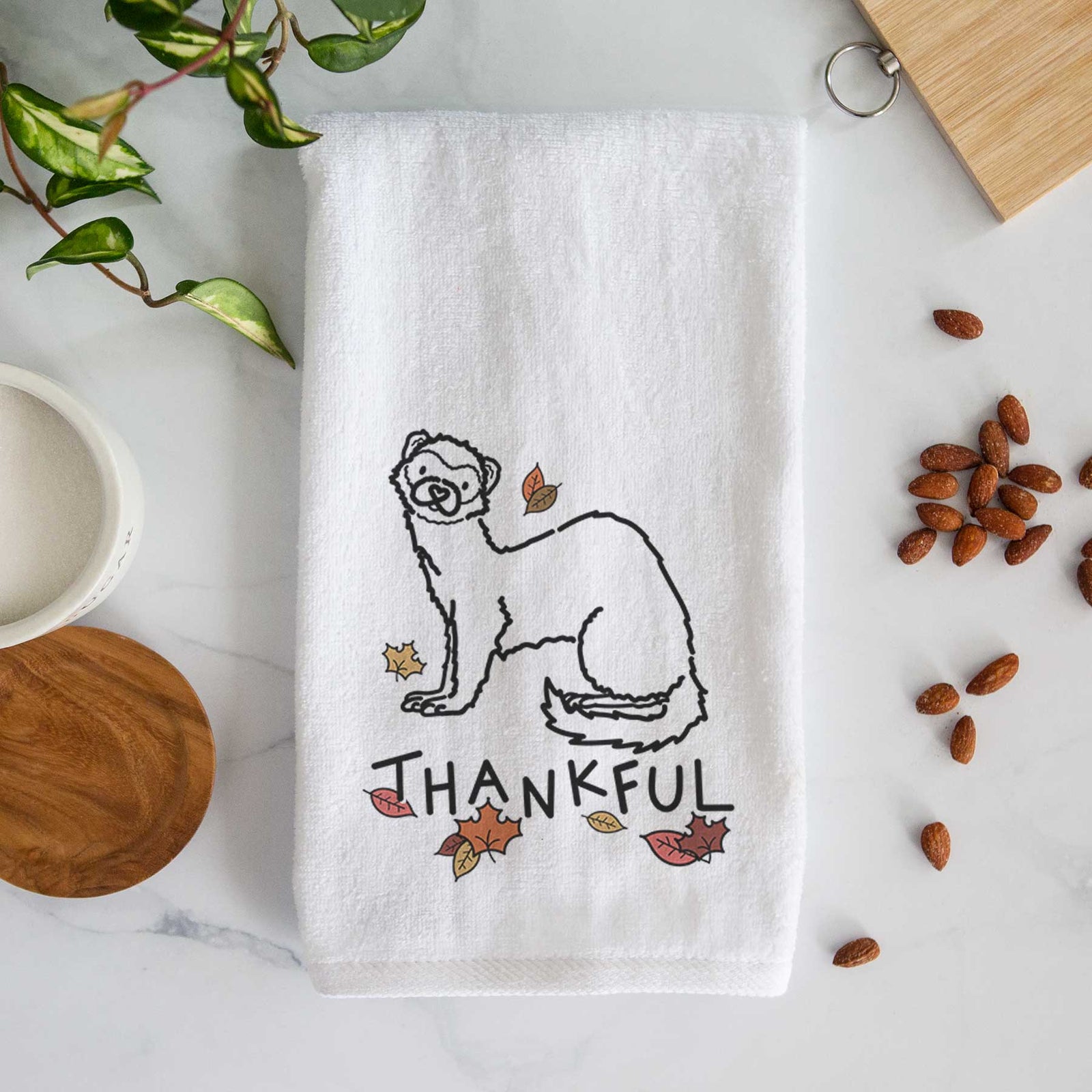Minimalist line drawing of Fern the Ferret with 'Thankful' lettering on a decorative hand towel