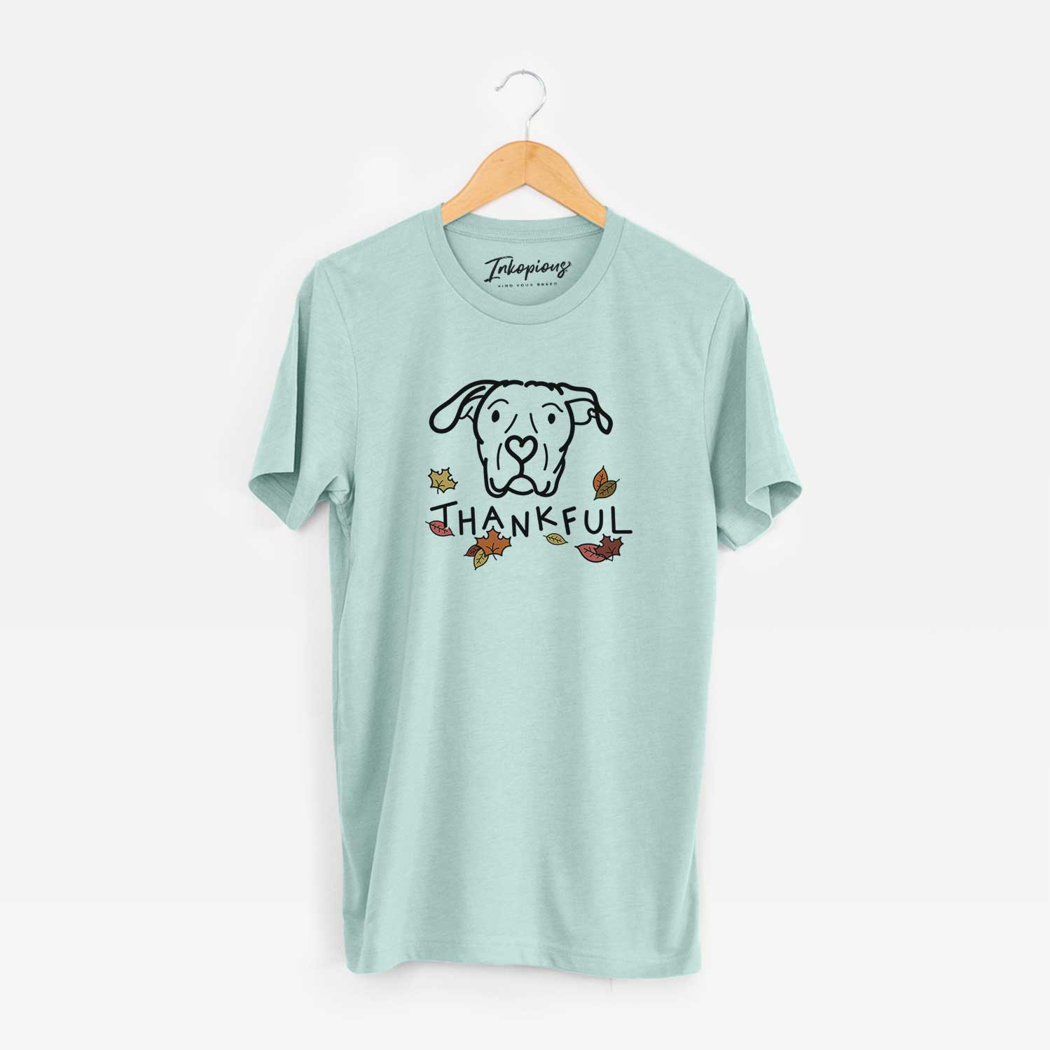 Minimalist line drawing of Genevieve the Dogo Argentino with 'Thankful' lettering on a Heather Sage Unisex crewneck