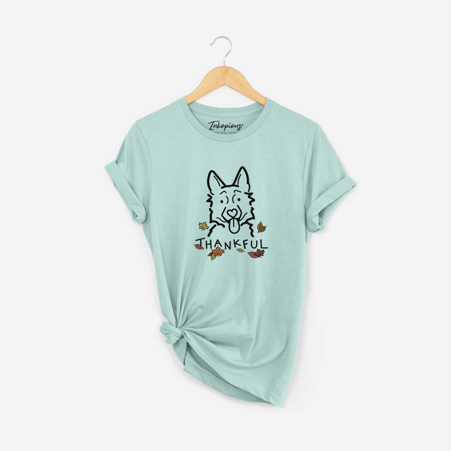 Minimalist line drawing of a German Shepherd with 'Thankful' lettering on a Heather Sage Unisex crewneck