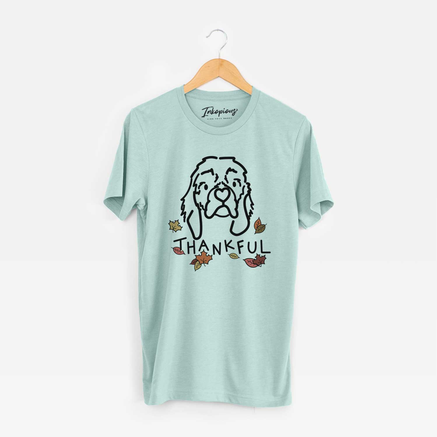 Minimalist line drawing of GiGi the Cocker Spaniel with 'Thankful' lettering on a Heather Sage Unisex crewneck