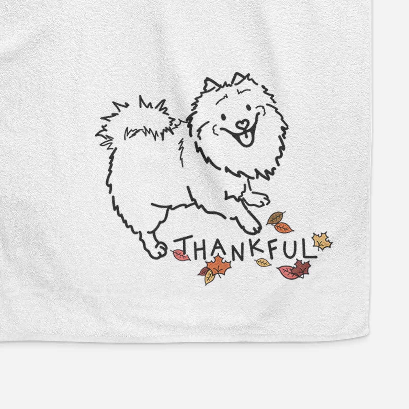 Minimalist line drawing of Goldie the Pomeranian Mix with 'Thankful' lettering on a decorative hand towel