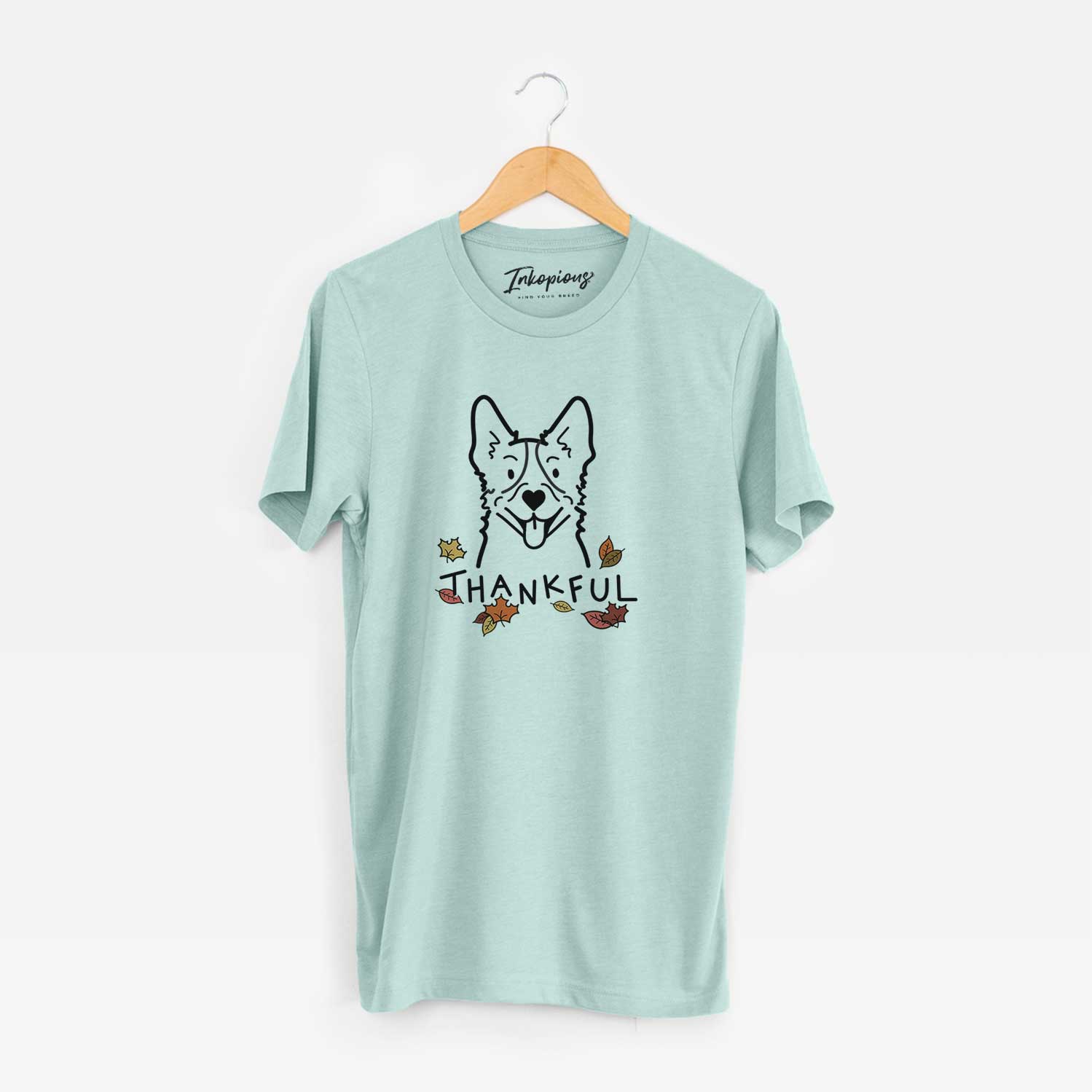 Minimalist line drawing of a Heeler with 'Thankful' lettering on a Heather Sage Unisex crewneck