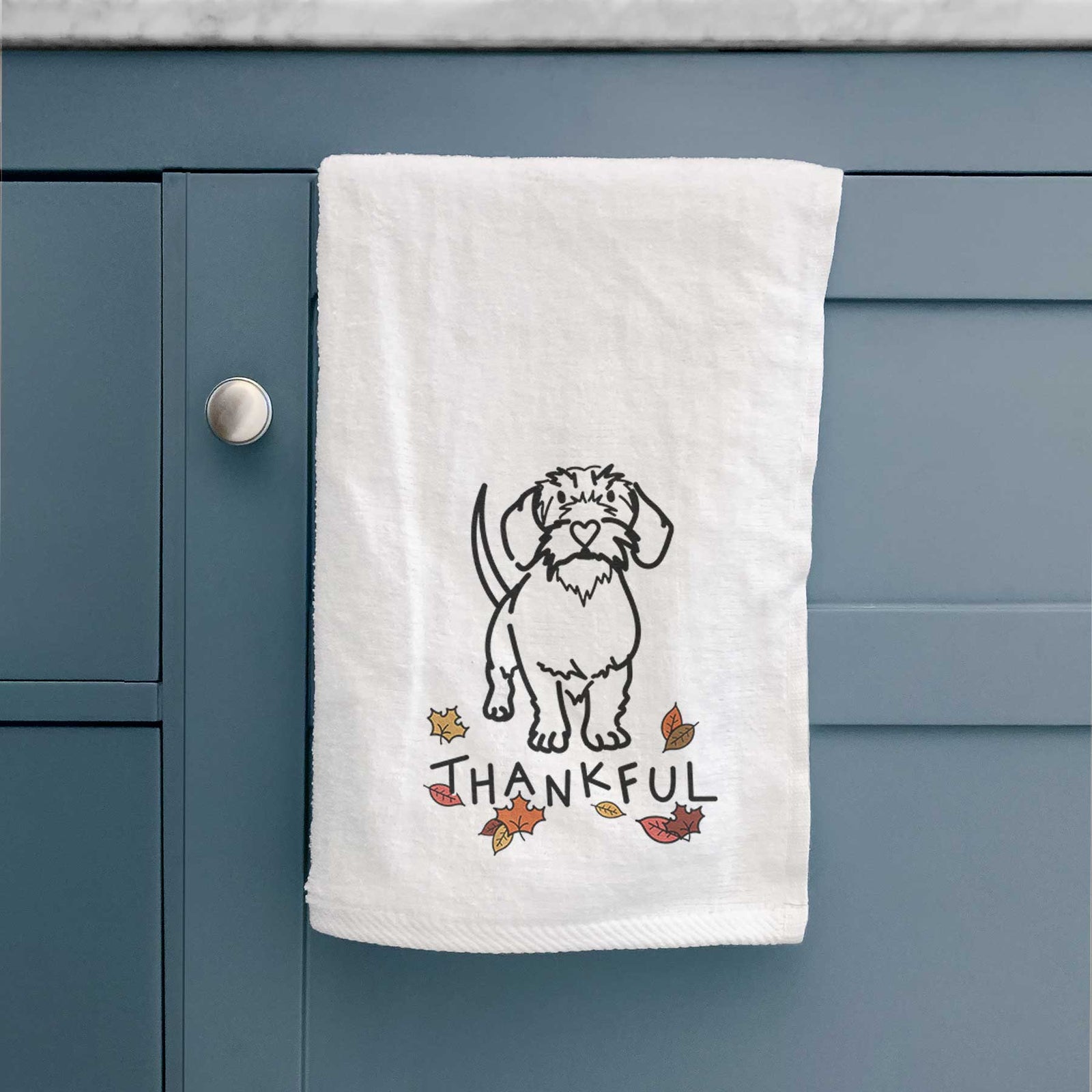 Minimalist line drawing of Henry the Wire Dachshund with 'Thankful' lettering on a decorative hand towel