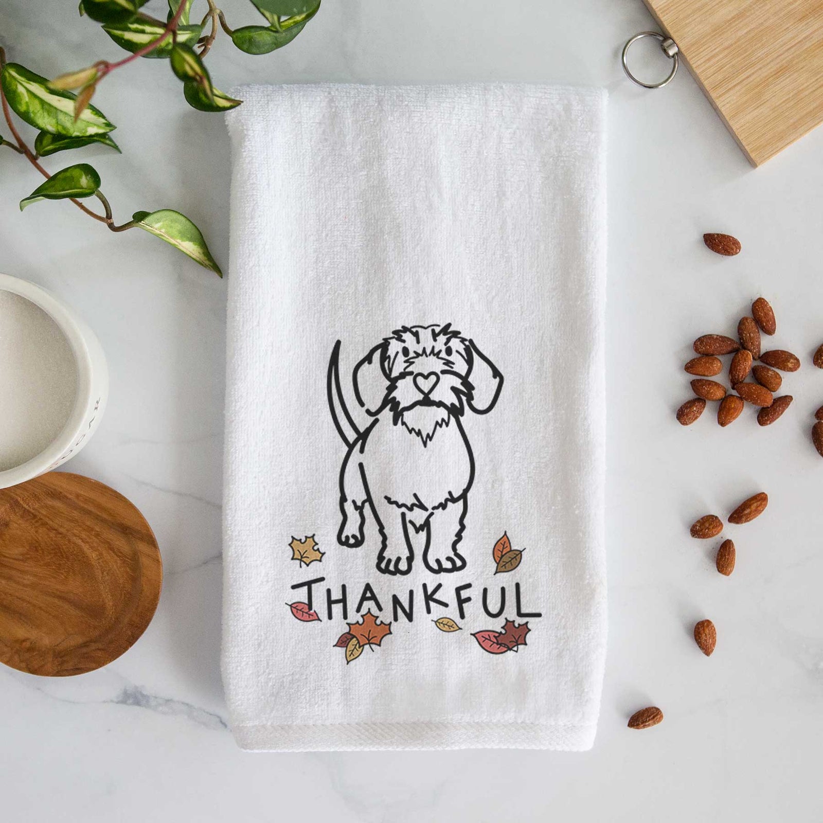 Minimalist line drawing of Henry the Wire Dachshund with 'Thankful' lettering on a decorative hand towel