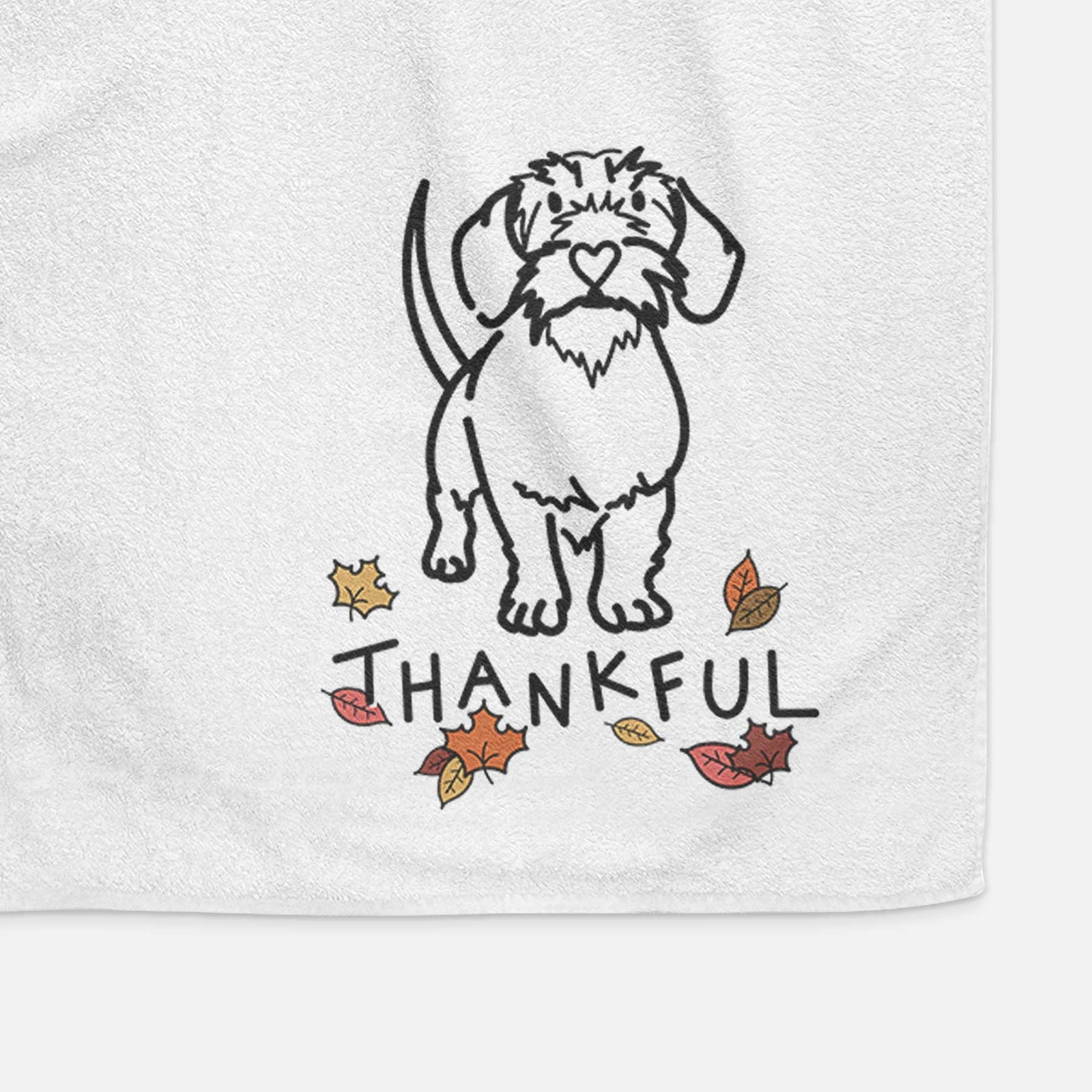 Minimalist line drawing of Henry the Wire Dachshund with 'Thankful' lettering on a decorative hand towel