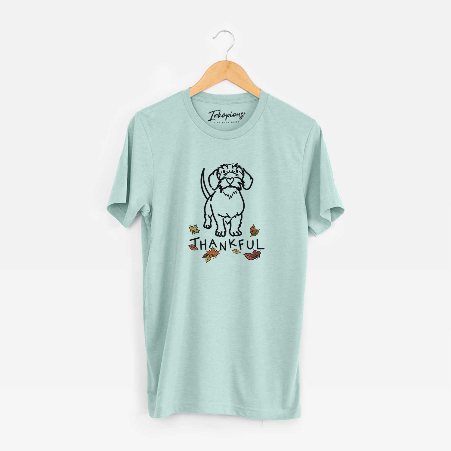 Minimalist line drawing of Henry the Wire Dachshund with 'Thankful' lettering on a Heather Sage Unisex crewneck