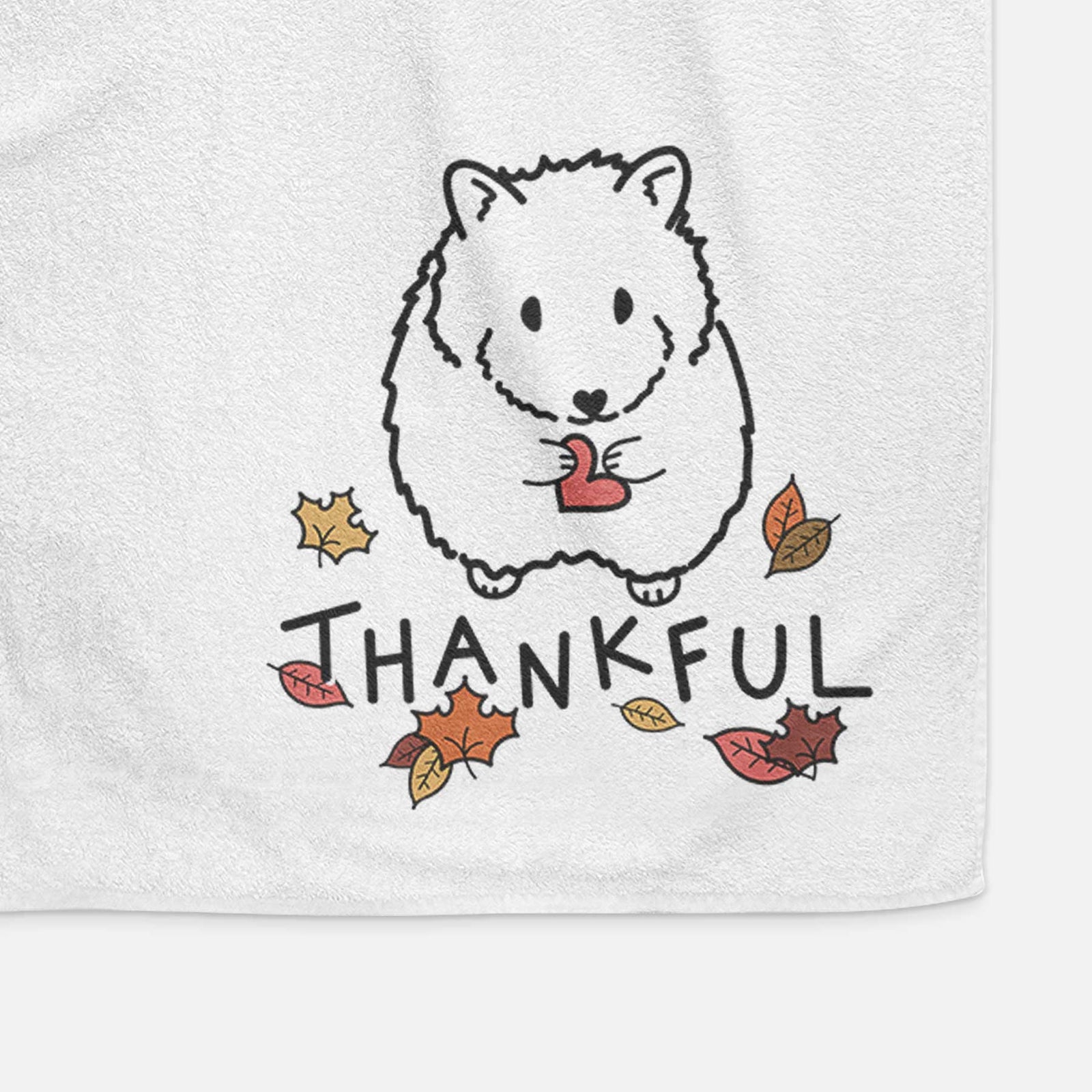 Minimalist line drawing of Hilga the Hamster with 'Thankful' lettering on a decorative hand towel
