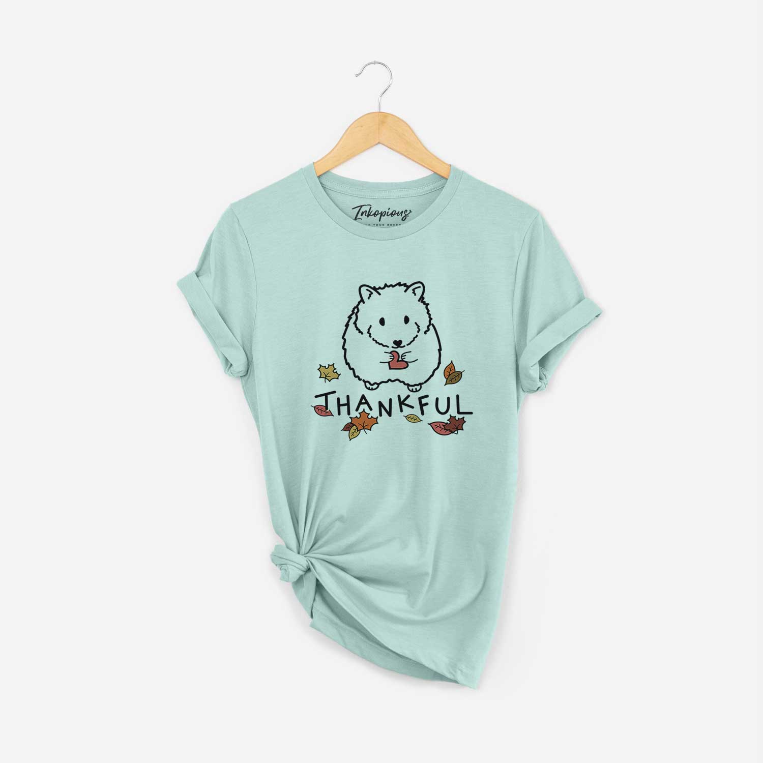 Minimalist line drawing of Hilga the Hamster with 'Thankful' lettering on a Heather Sage Unisex crewneck