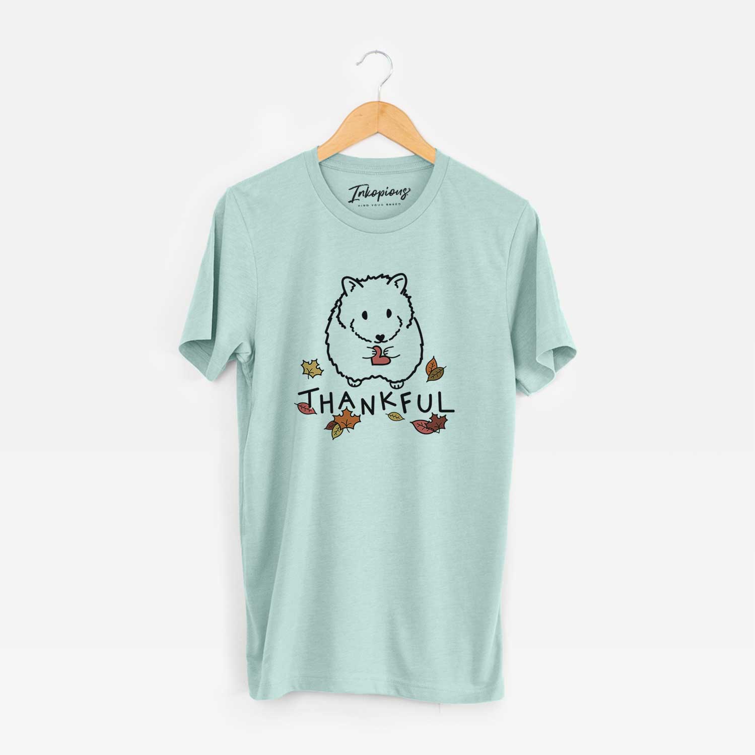 Minimalist line drawing of Hilga the Hamster with 'Thankful' lettering on a Heather Sage Unisex crewneck