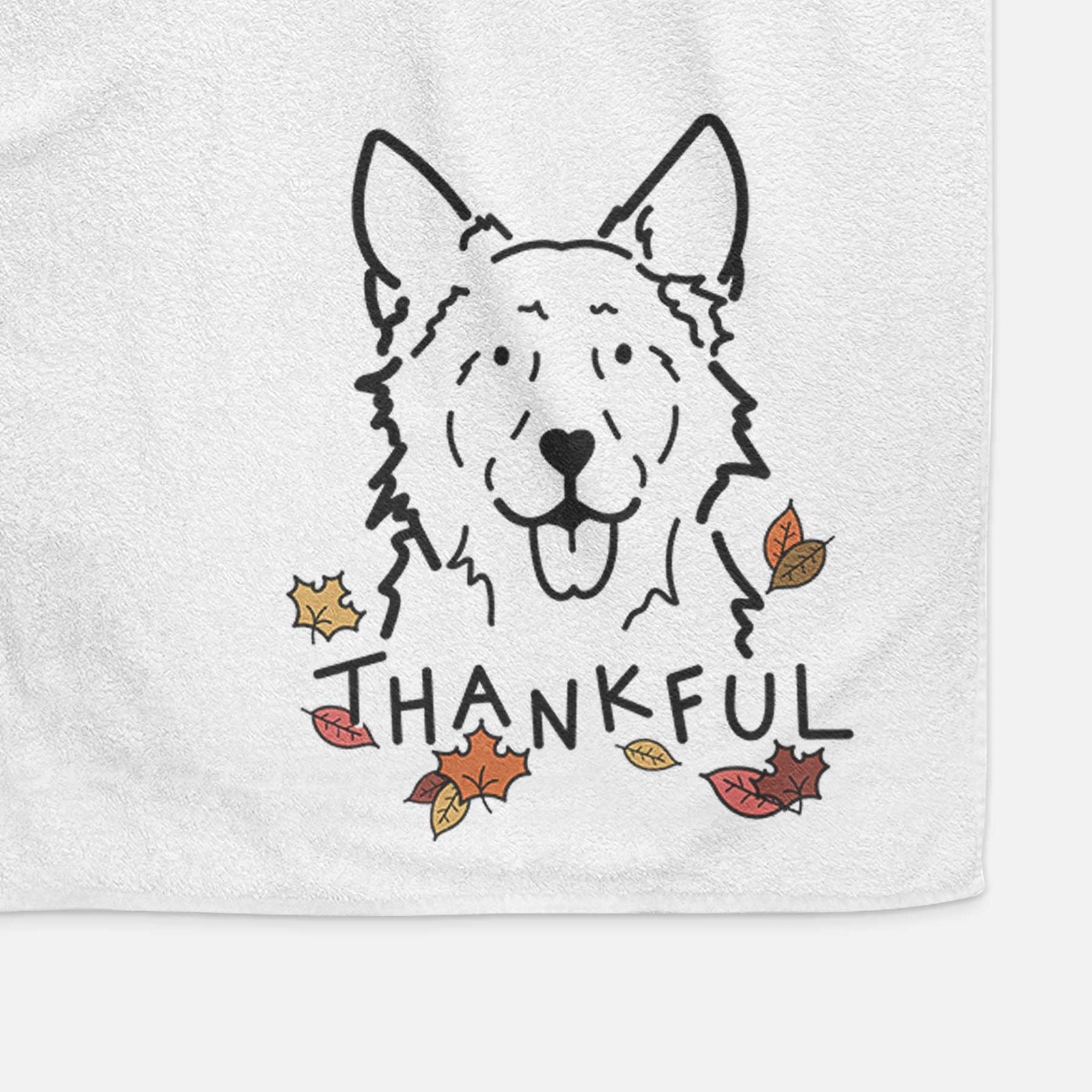 Minimalist line drawing of Jack the Mudi with 'Thankful' lettering on a decorative hand towel