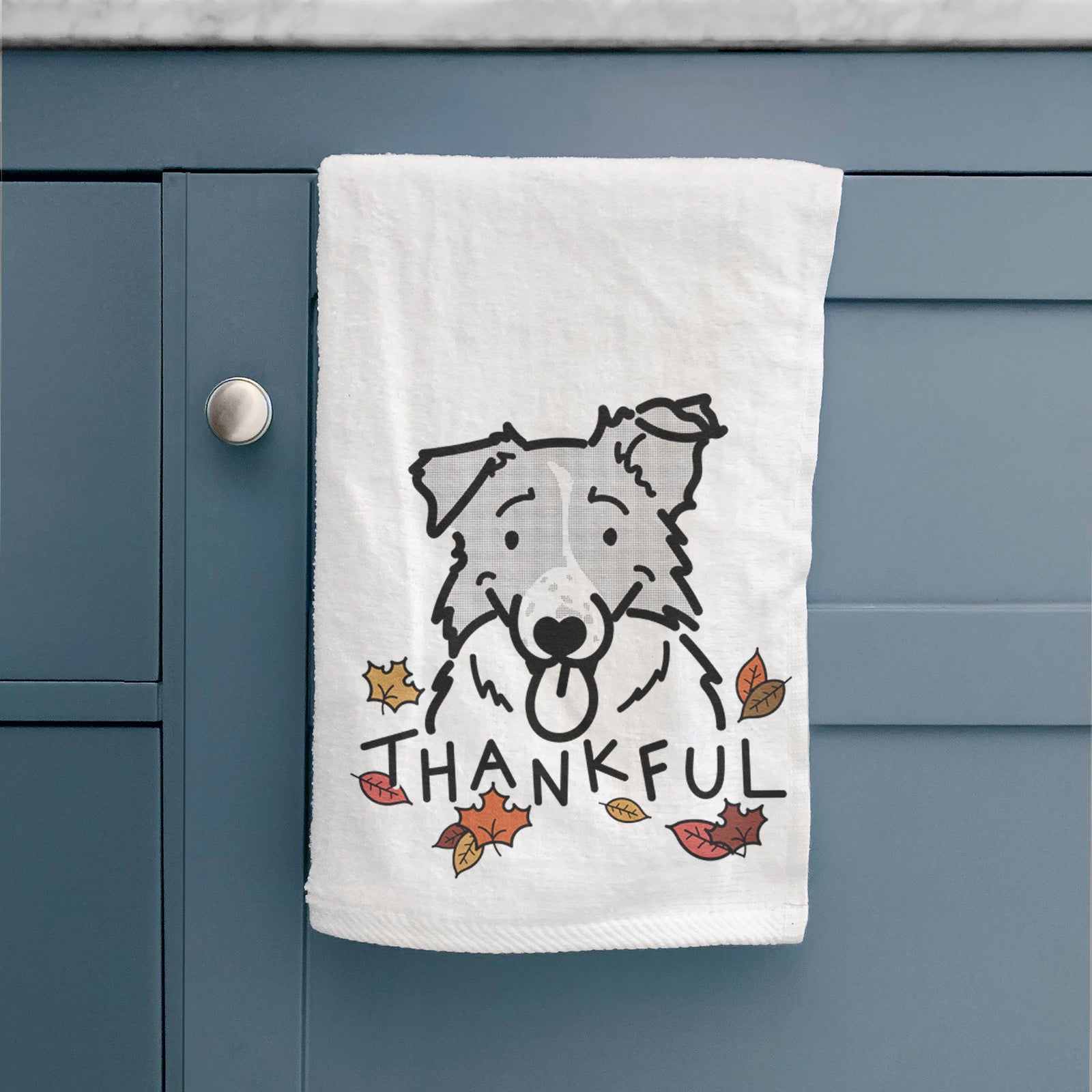 Minimalist line drawing of Jam the Border Collie with 'Thankful' lettering on a decorative hand towel