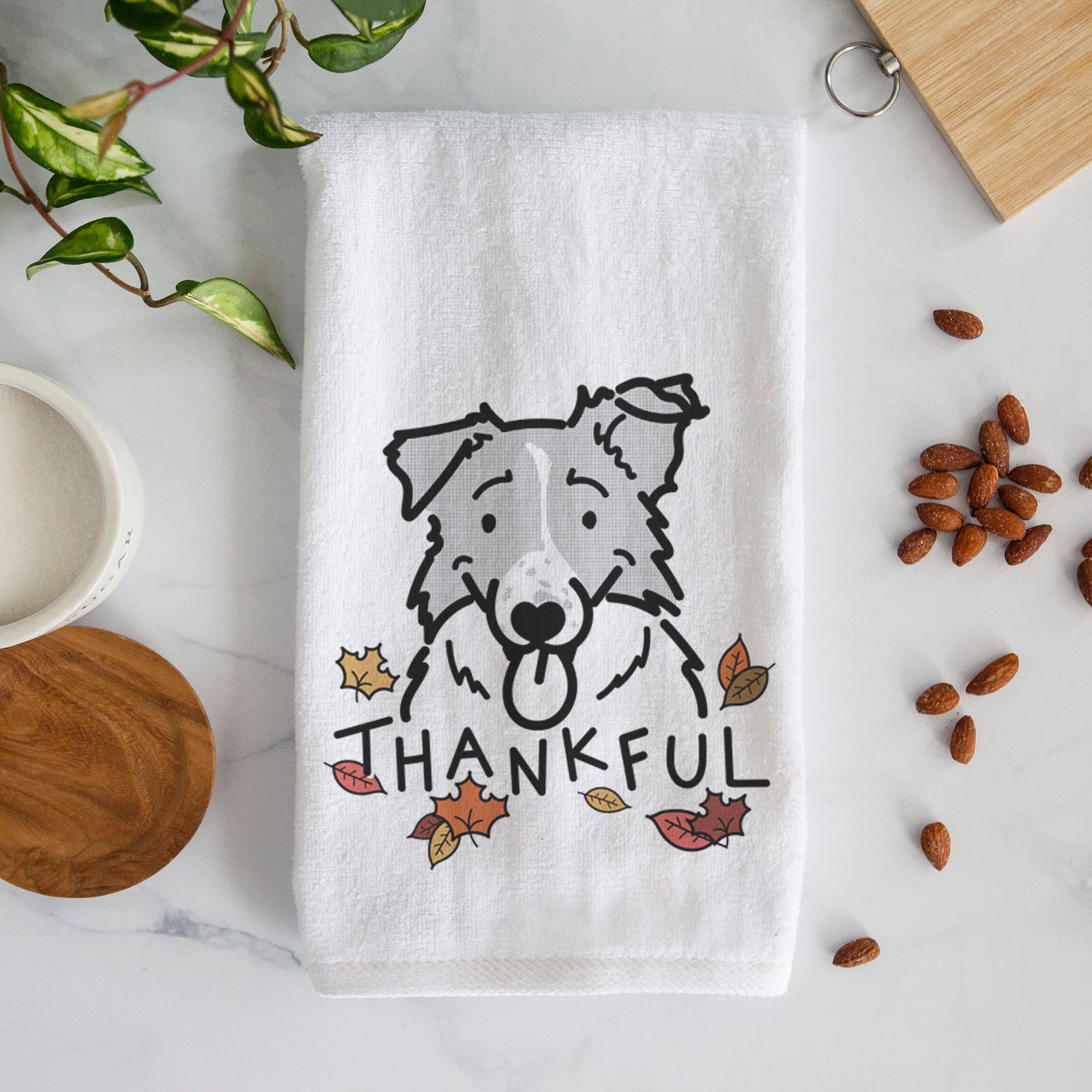 Minimalist line drawing of Jam the Border Collie with 'Thankful' lettering on a decorative hand towel