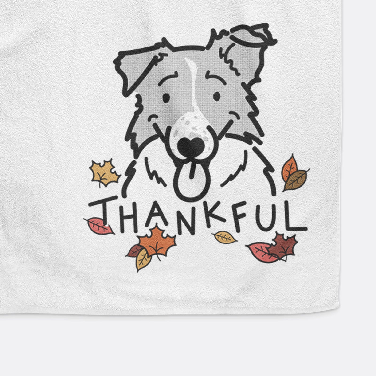 Minimalist line drawing of Jam the Border Collie with 'Thankful' lettering on a decorative hand towel