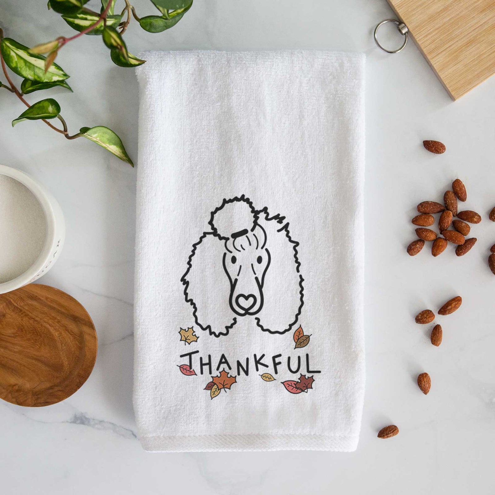 Minimalist line drawing of Jemma the Standard Poodle with 'Thankful' lettering on a decorative hand towel