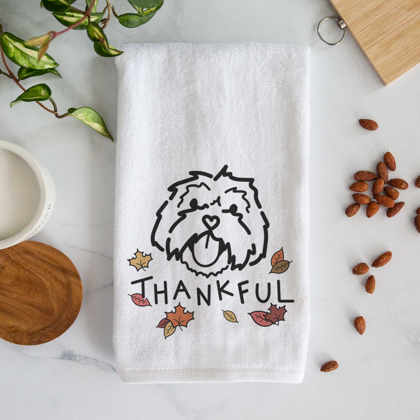 Minimalist line drawing of Keia the Lhasa Apso with 'Thankful' lettering on a decorative hand towel