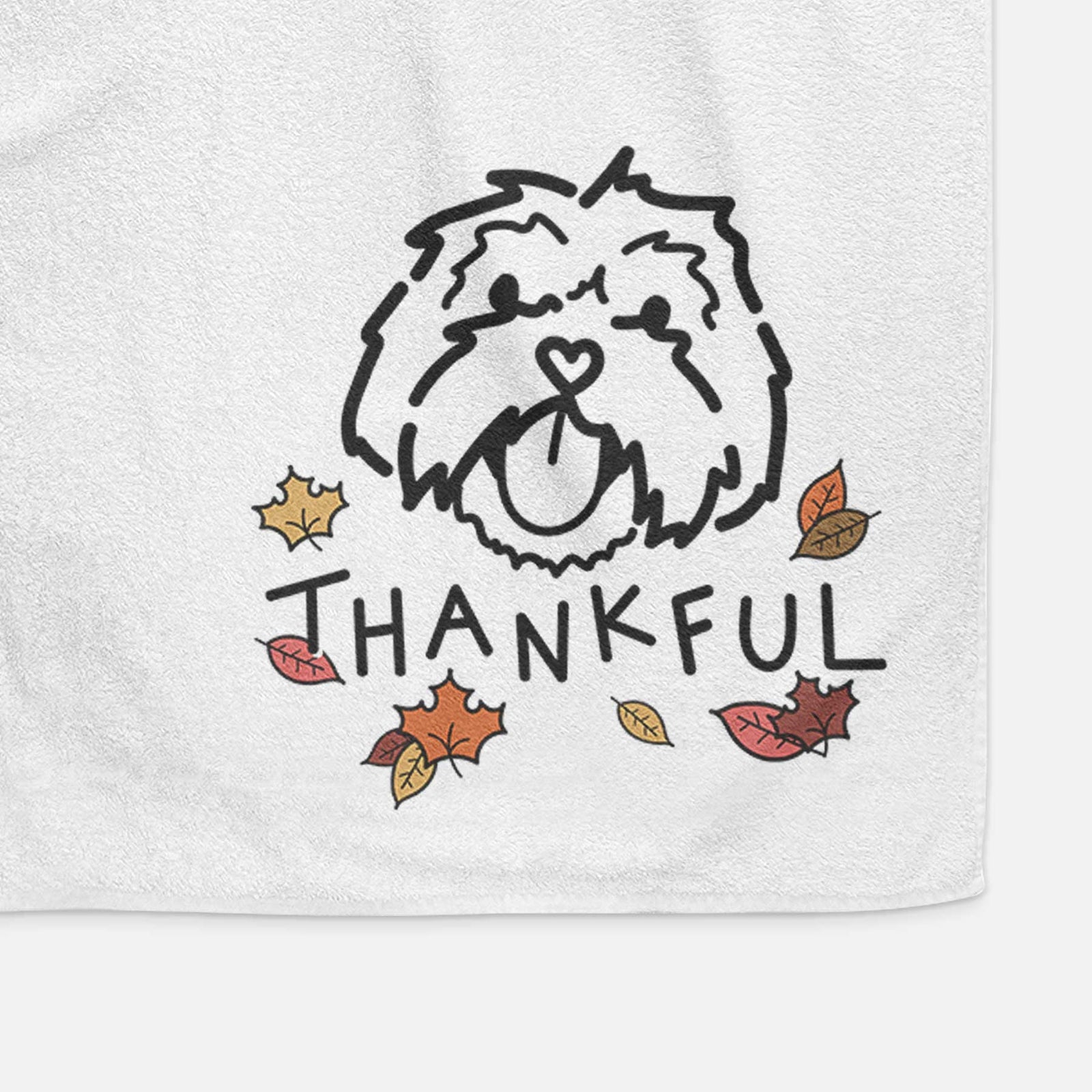Minimalist line drawing of Keia the Lhasa Apso with 'Thankful' lettering on a decorative hand towel