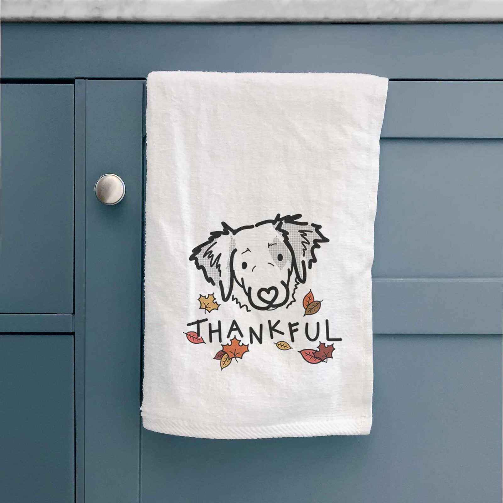 Minimalist line drawing of Kiva the Brittany Spaniel with 'Thankful' lettering on a decorative hand towel