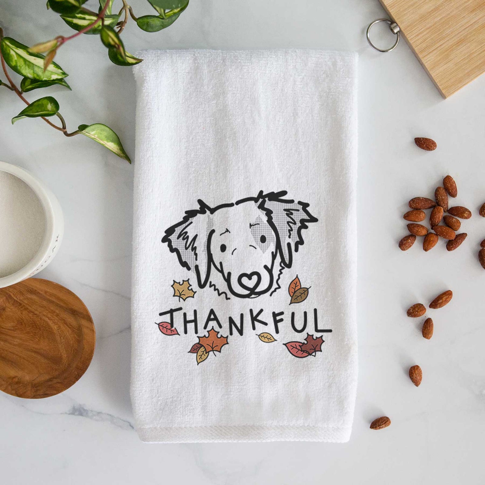 Minimalist line drawing of Kiva the Brittany Spaniel with 'Thankful' lettering on a decorative hand towel