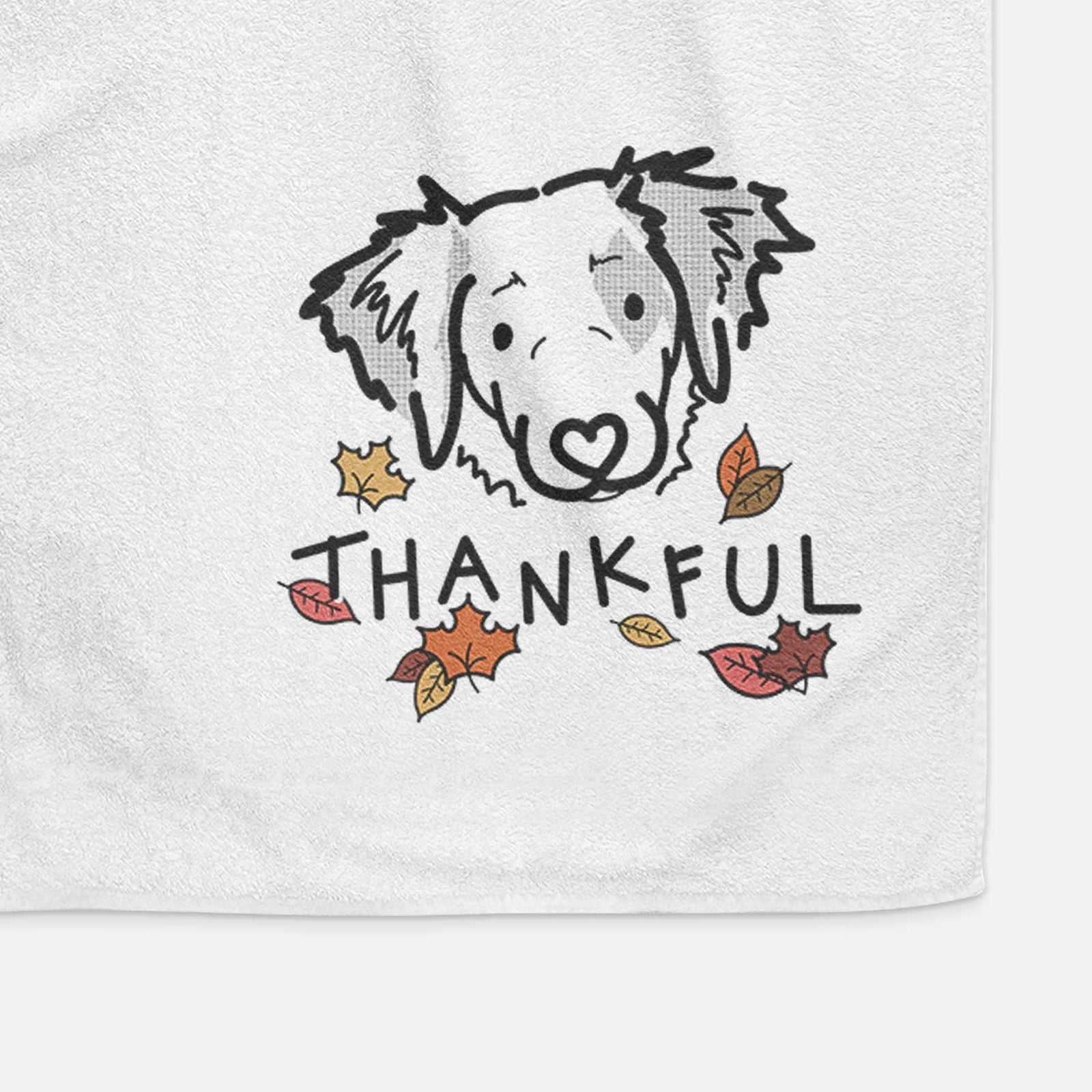 Minimalist line drawing of Kiva the Brittany Spaniel with 'Thankful' lettering on a decorative hand towel