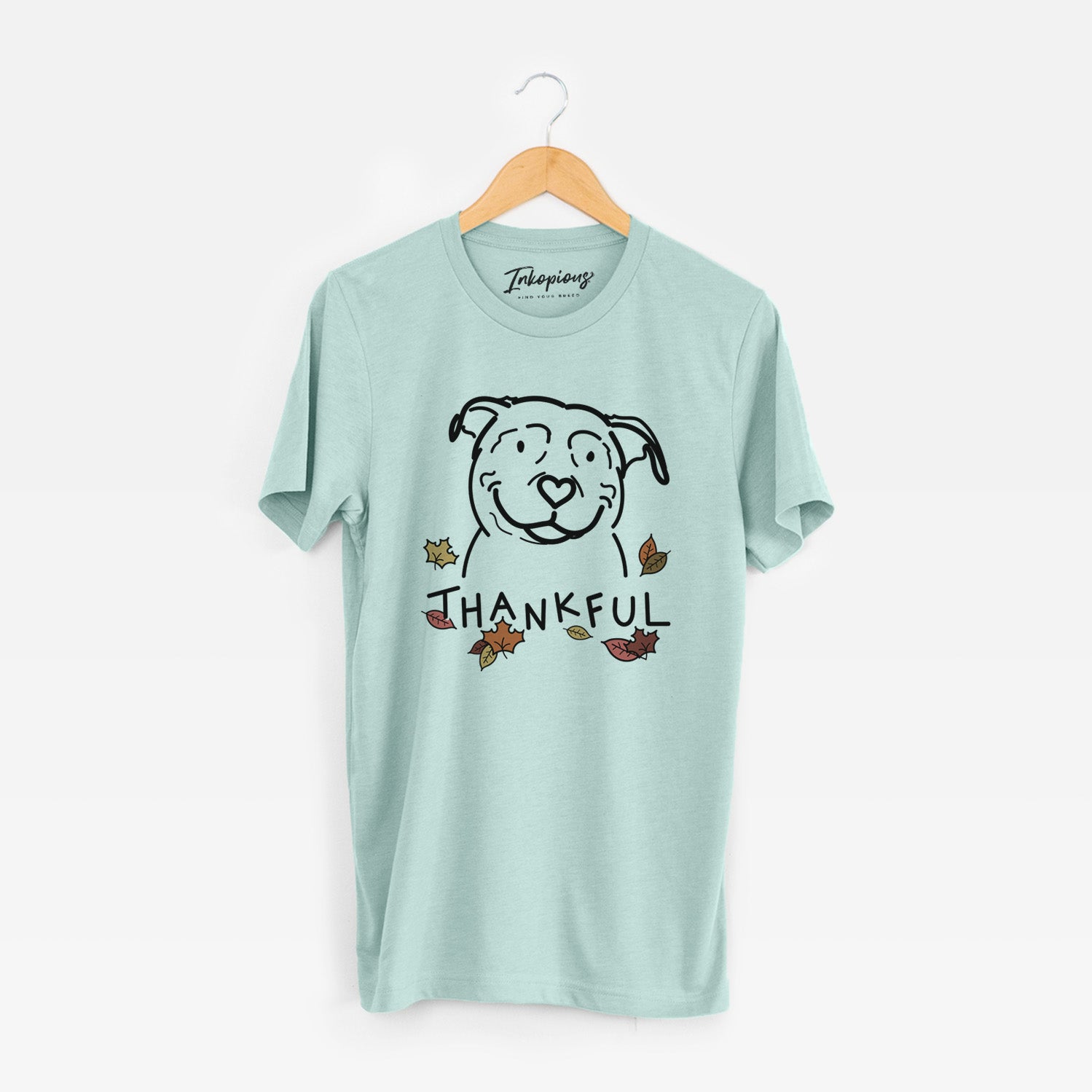 Minimalist line drawing of Lady the American Pitbull Terrier with 'Thankful' lettering on a Heather Sage Unisex crewneck