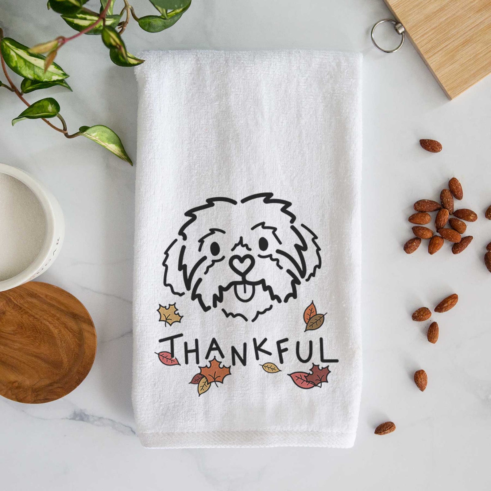 Minimalist line drawing of Leo the Shih Tzu with 'Thankful' lettering on a decorative hand towel