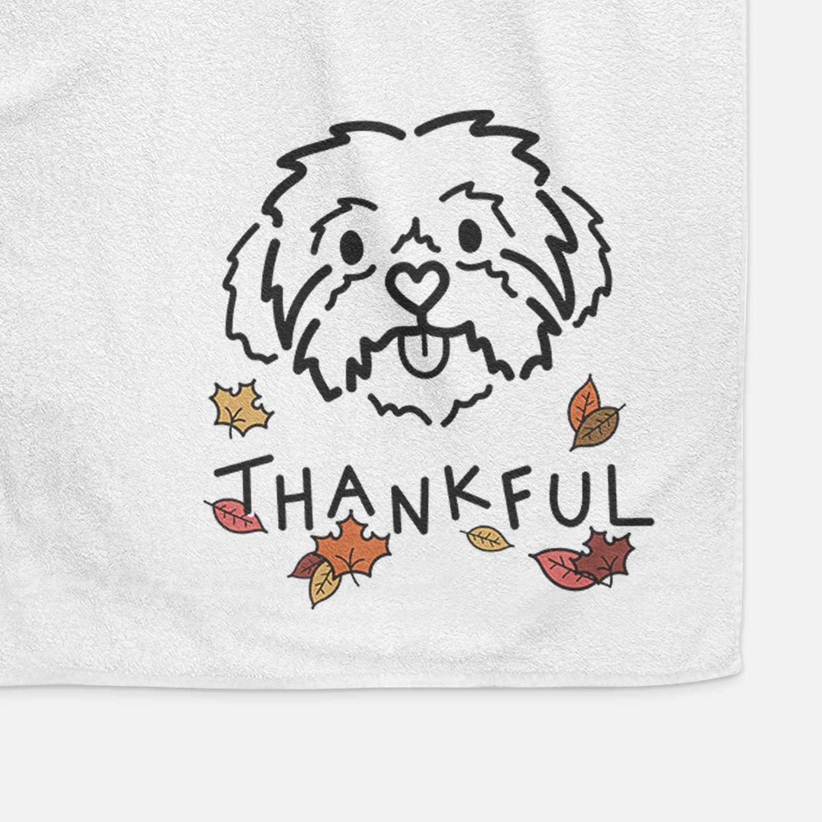 Minimalist line drawing of Leo the Shih Tzu with 'Thankful' lettering on a decorative hand towel