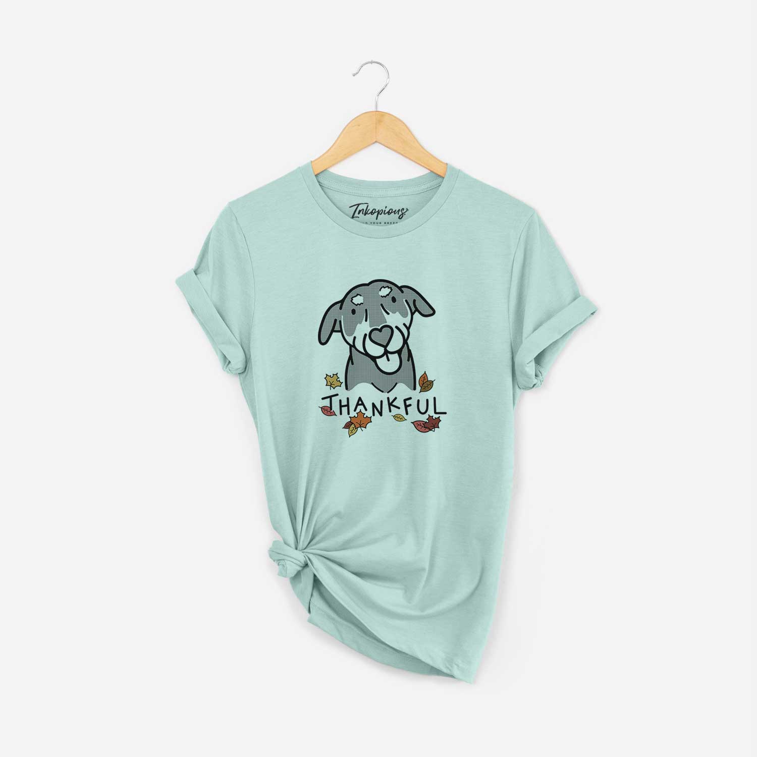 Minimalist line drawing of Lousia the Mixed Breed with 'Thankful' lettering on a Heather Sage Unisex crewneck