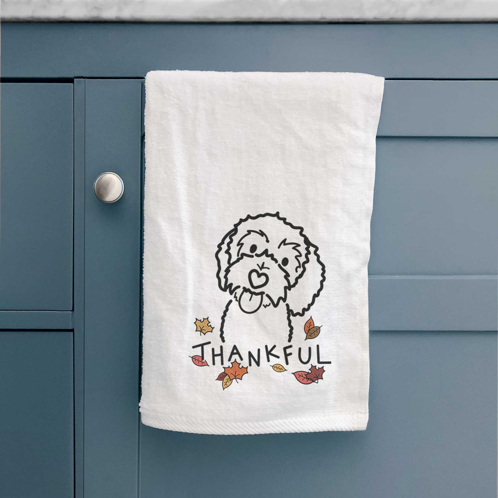 Minimalist line drawing of Mabel the Bernedoodle with 'Thankful' lettering on a decorative hand towel