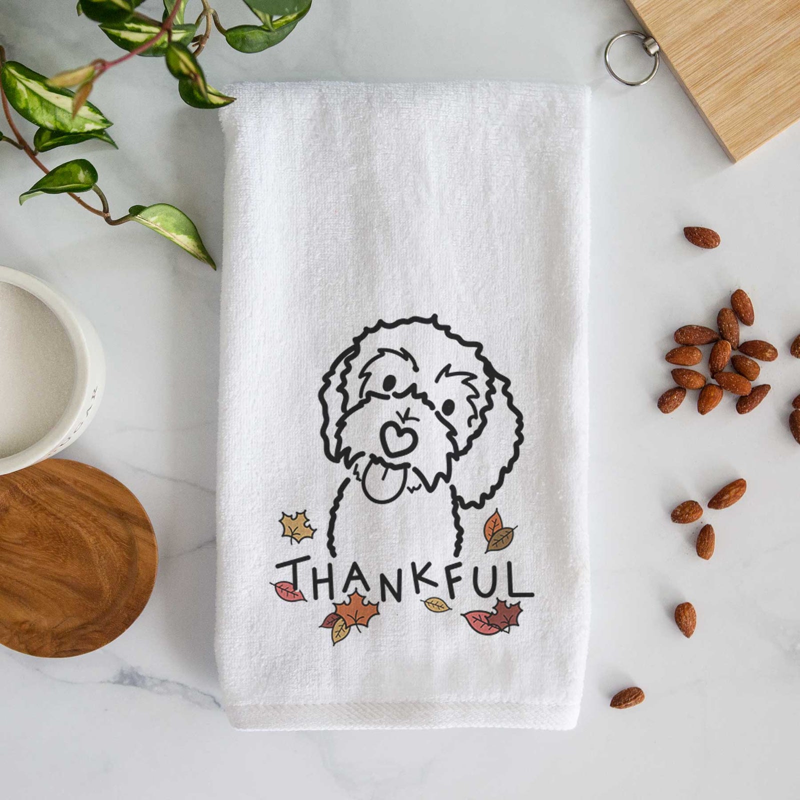 Minimalist line drawing of Mabel the Bernedoodle with 'Thankful' lettering on a decorative hand towel