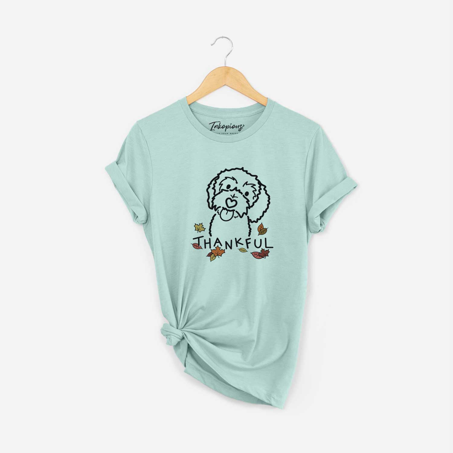 Minimalist line drawing of Mabel the Bernedoodle with 'Thankful' lettering on a Heather Sage Unisex crewneck