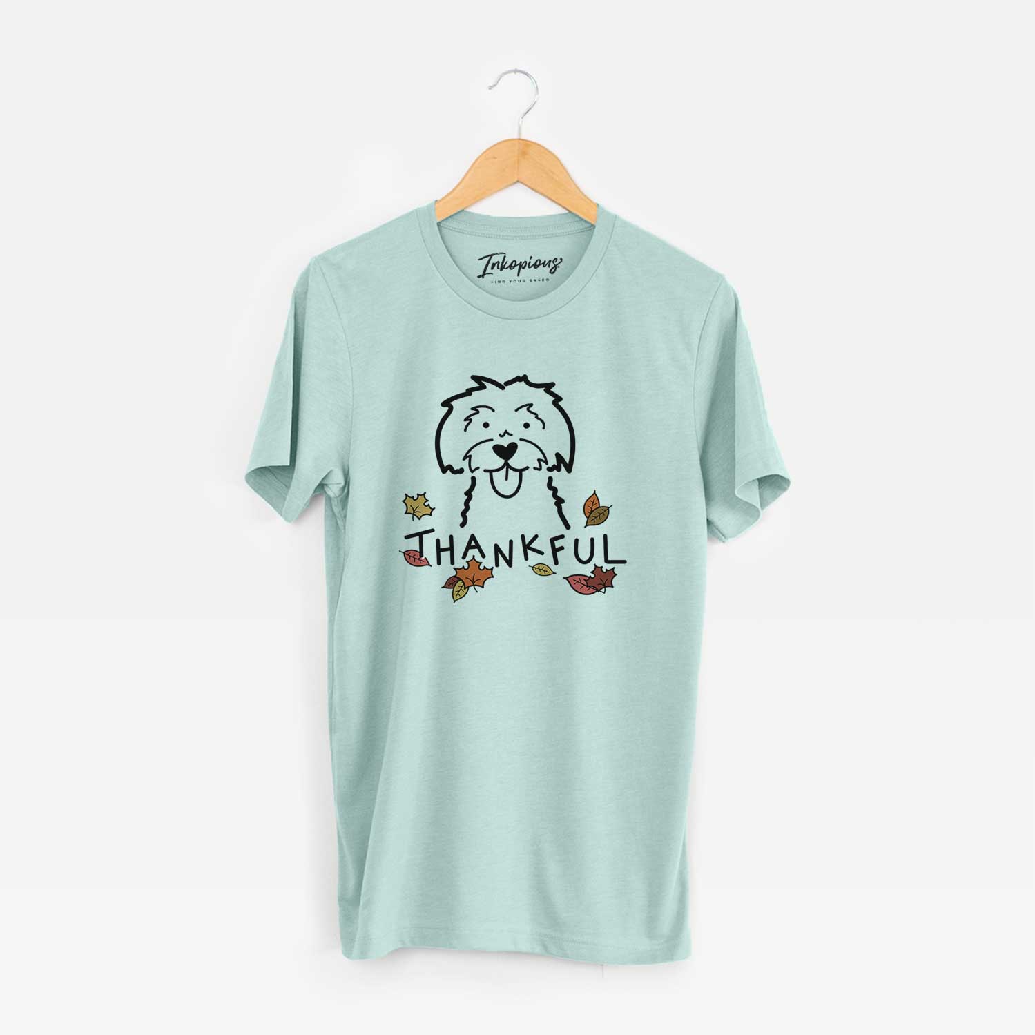 Minimalist line drawing of a Maltese with 'Thankful' lettering on a Heather Sage Unisex crewneck