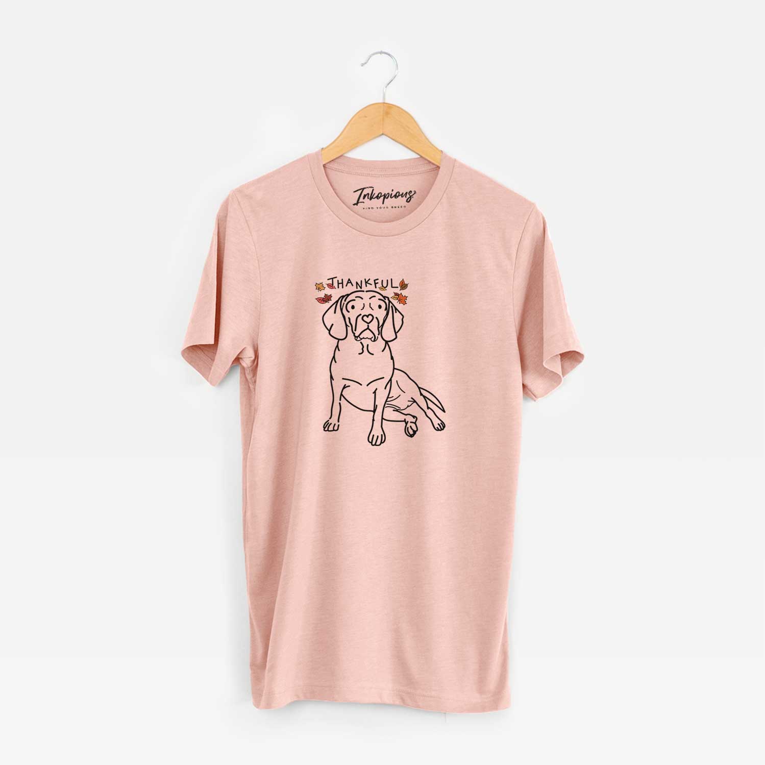 Minimalist line drawing of Mayble the Puggle with 'Thankful' lettering on a Peach Unisex crewneck