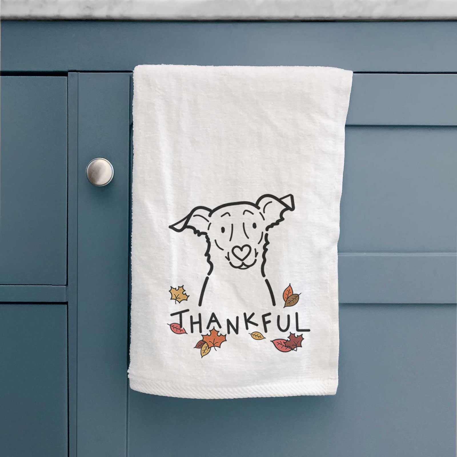 Minimalist line drawing of Millie the Border Collie Mix with 'Thankful' lettering on a decorative hand towel