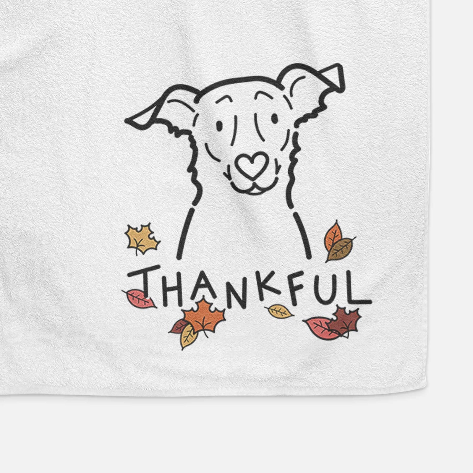 Minimalist line drawing of Millie the Border Collie Mix with 'Thankful' lettering on a decorative hand towel