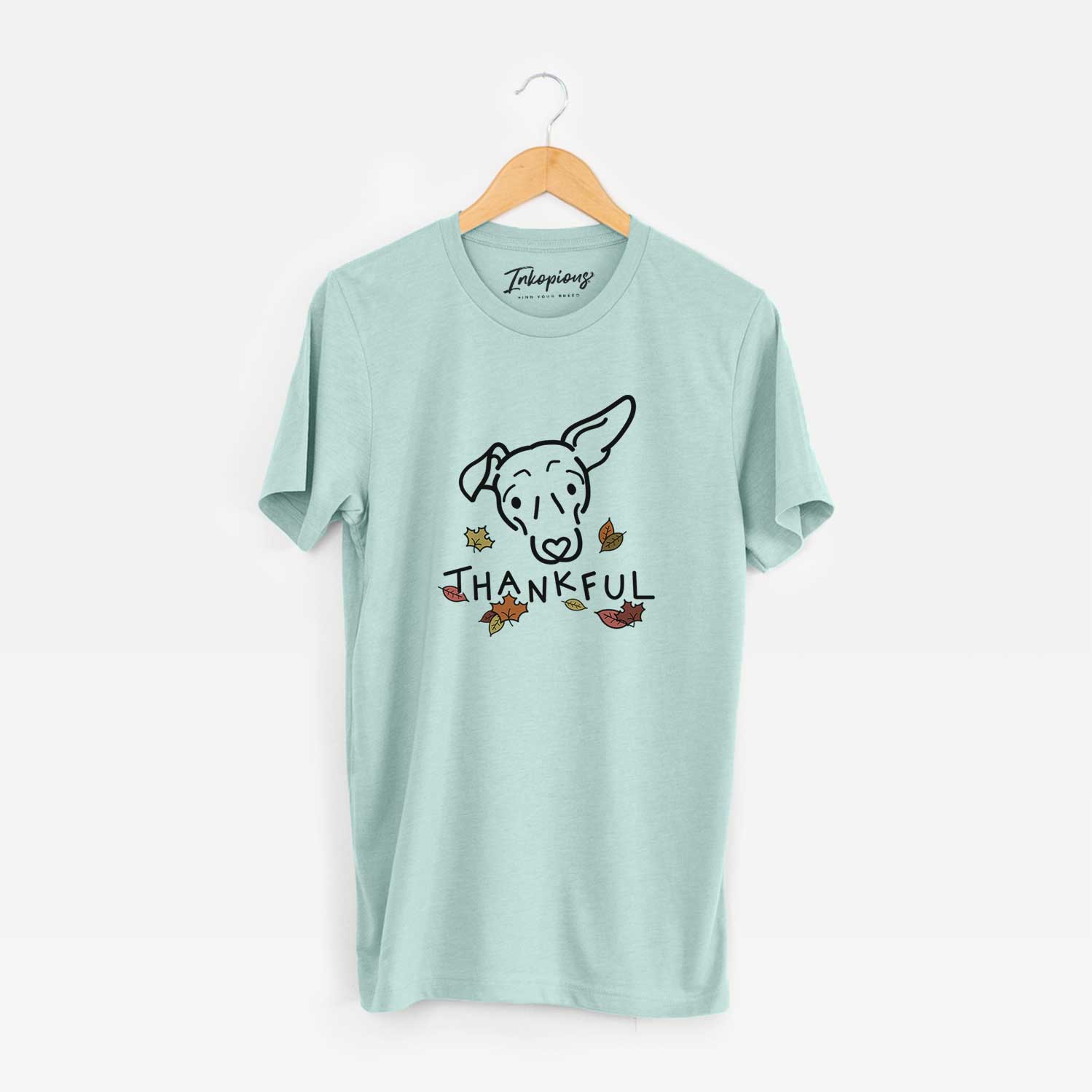 Minimalist line drawing of Millie the Mixed Breed with 'Thankful' lettering on a Heather Sage Unisex crewneck