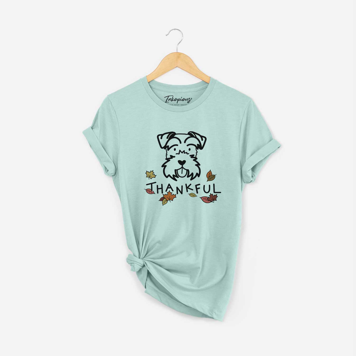 Minimalist line drawing of a Miniature Schnauzer with 'Thankful' lettering on a Heather Sage Unisex crewneck