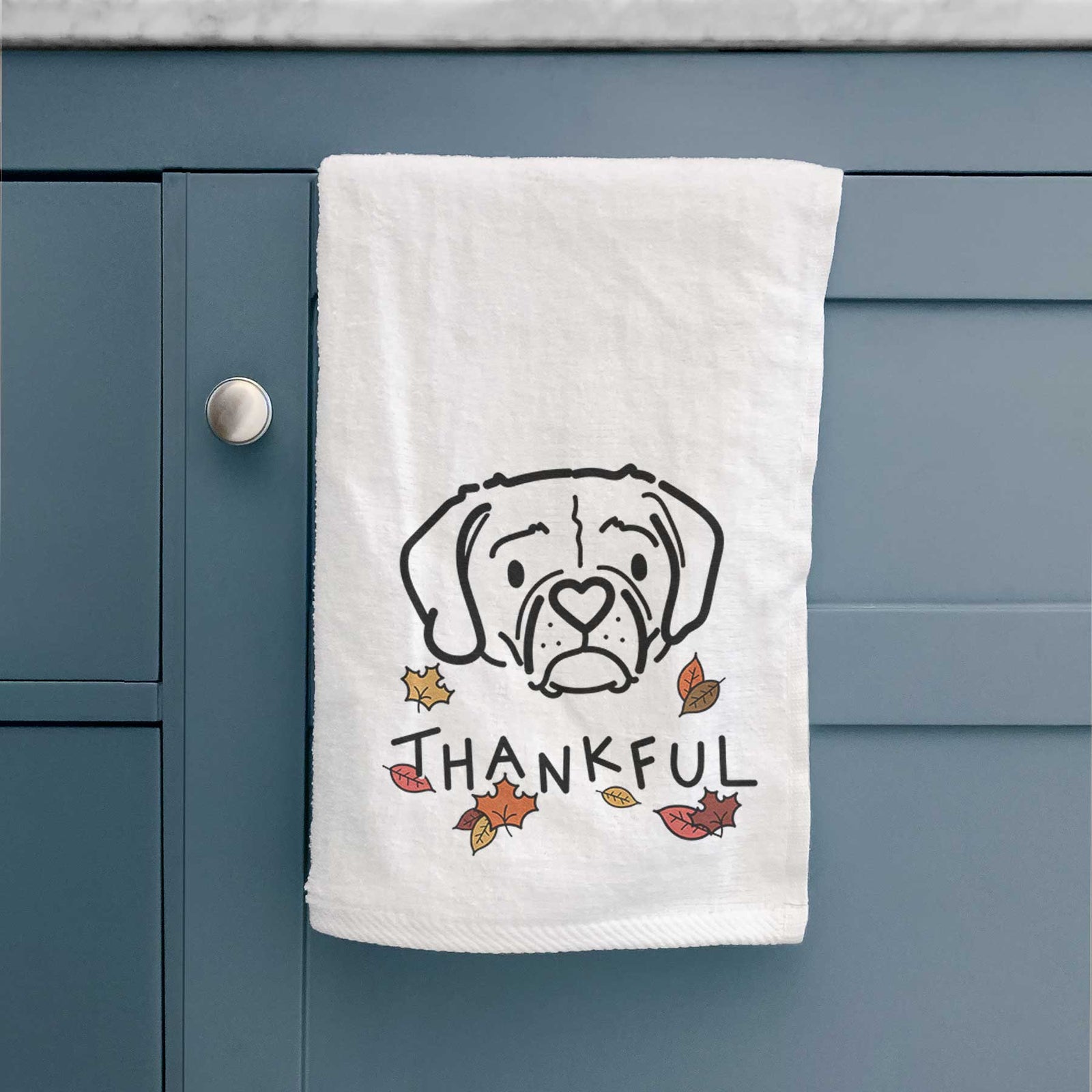 Minimalist line drawing of Mitzi the Puggle with 'Thankful' lettering on a decorative hand towel