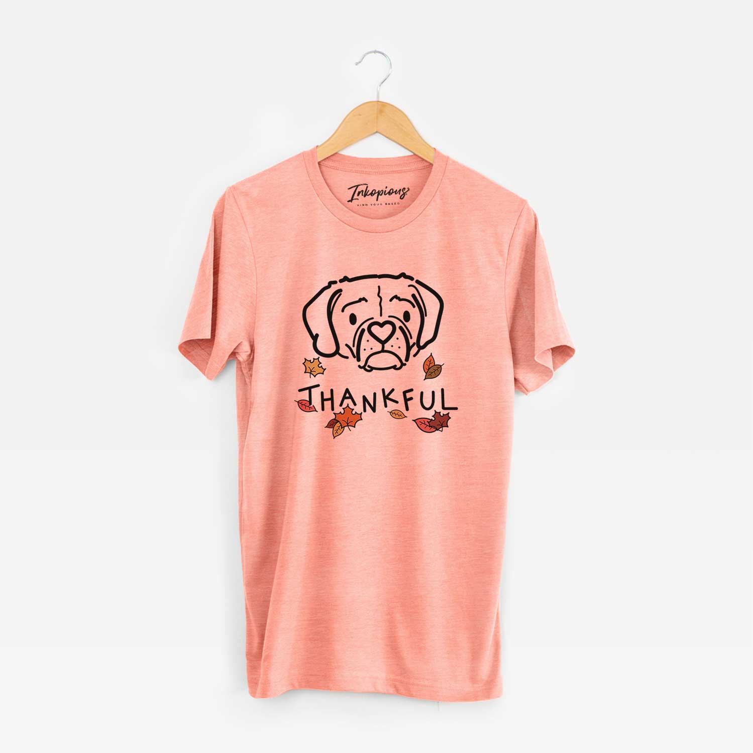 Minimalist line drawing of Mitzi the Puggle with 'Thankful' lettering on a Sunset Unisex crewneck