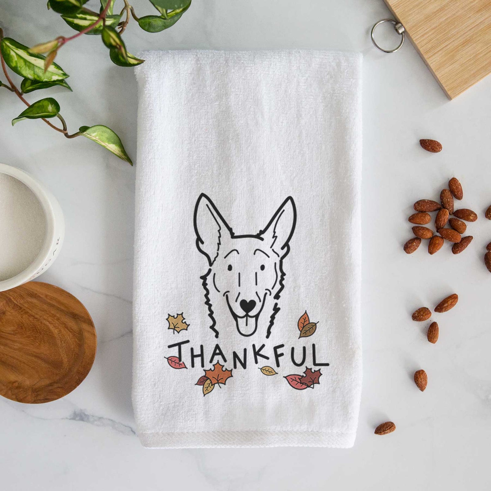 Minimalist line drawing of Mochi the Carolina Dog with 'Thankful' lettering on a decorative hand towel