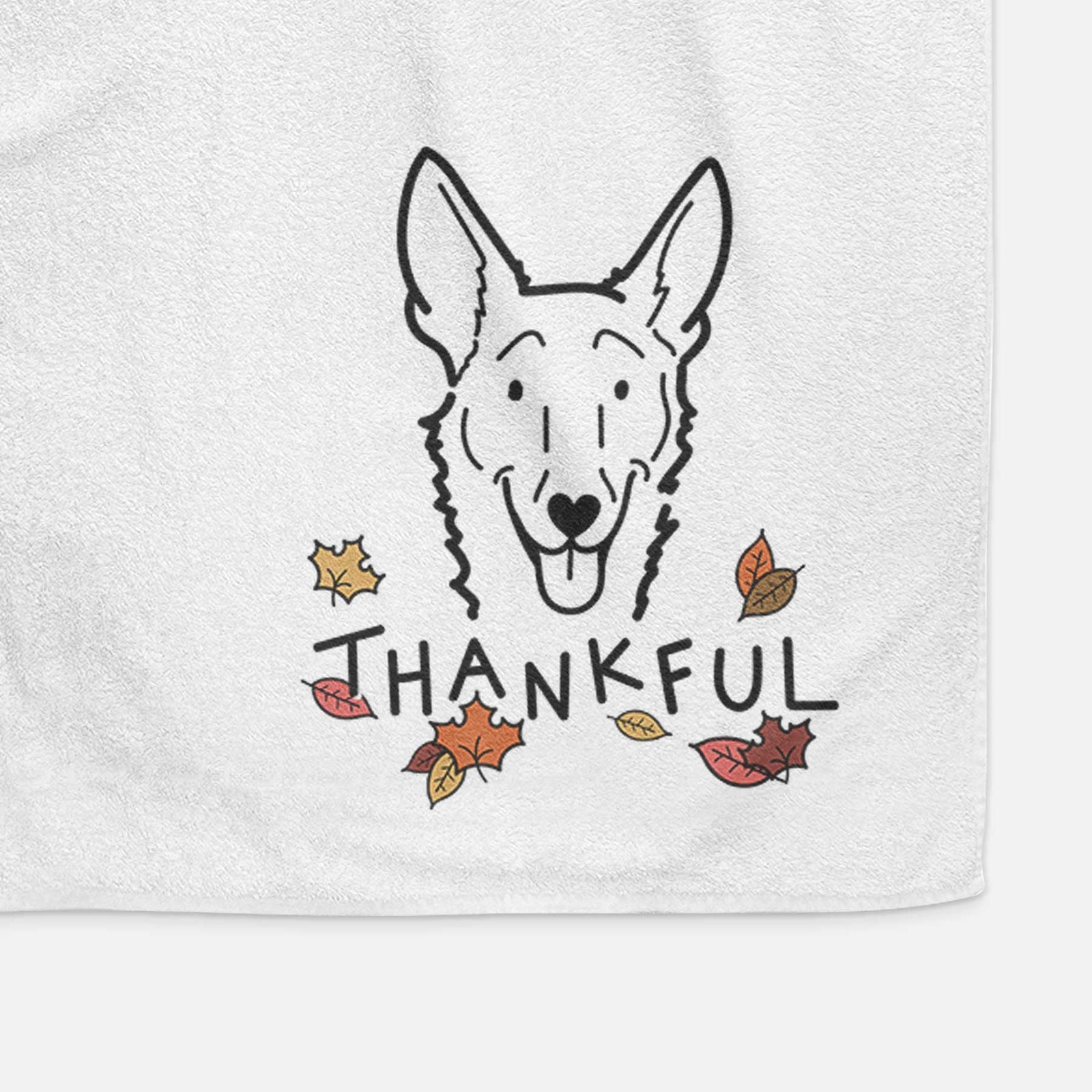 Minimalist line drawing of Mochi the Carolina Dog with 'Thankful' lettering on a decorative hand towel
