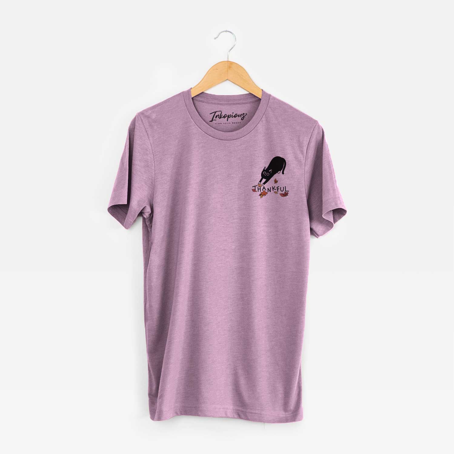 Small chest-pocket minimalist line drawing of Bug the Black Cat with 'Thankful' lettering on an Orchid Unisex crewneck