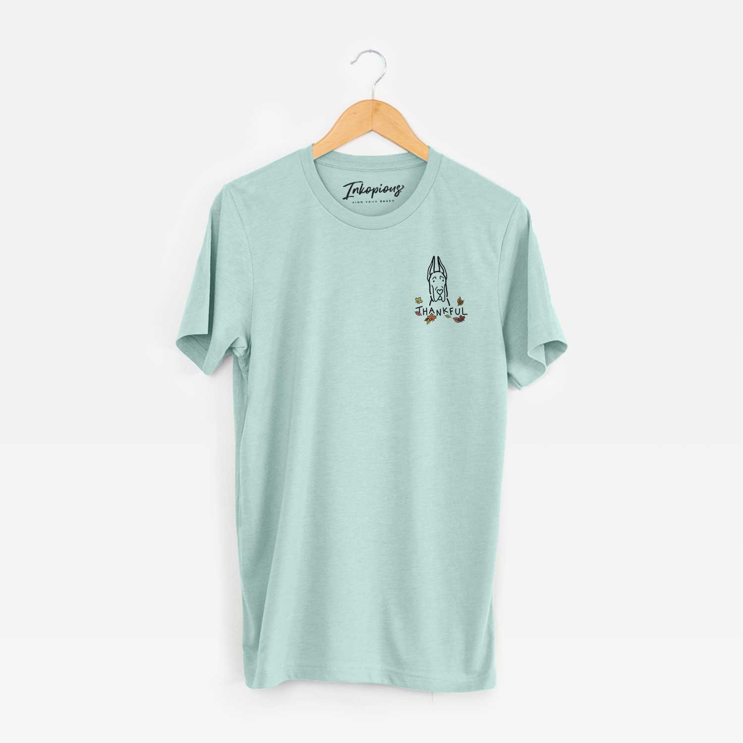 Small chest-pocket minimalist line drawing of a Great Dane with Cropped Ears with 'Thankful' lettering on a Heather Sage Unisex crewneck