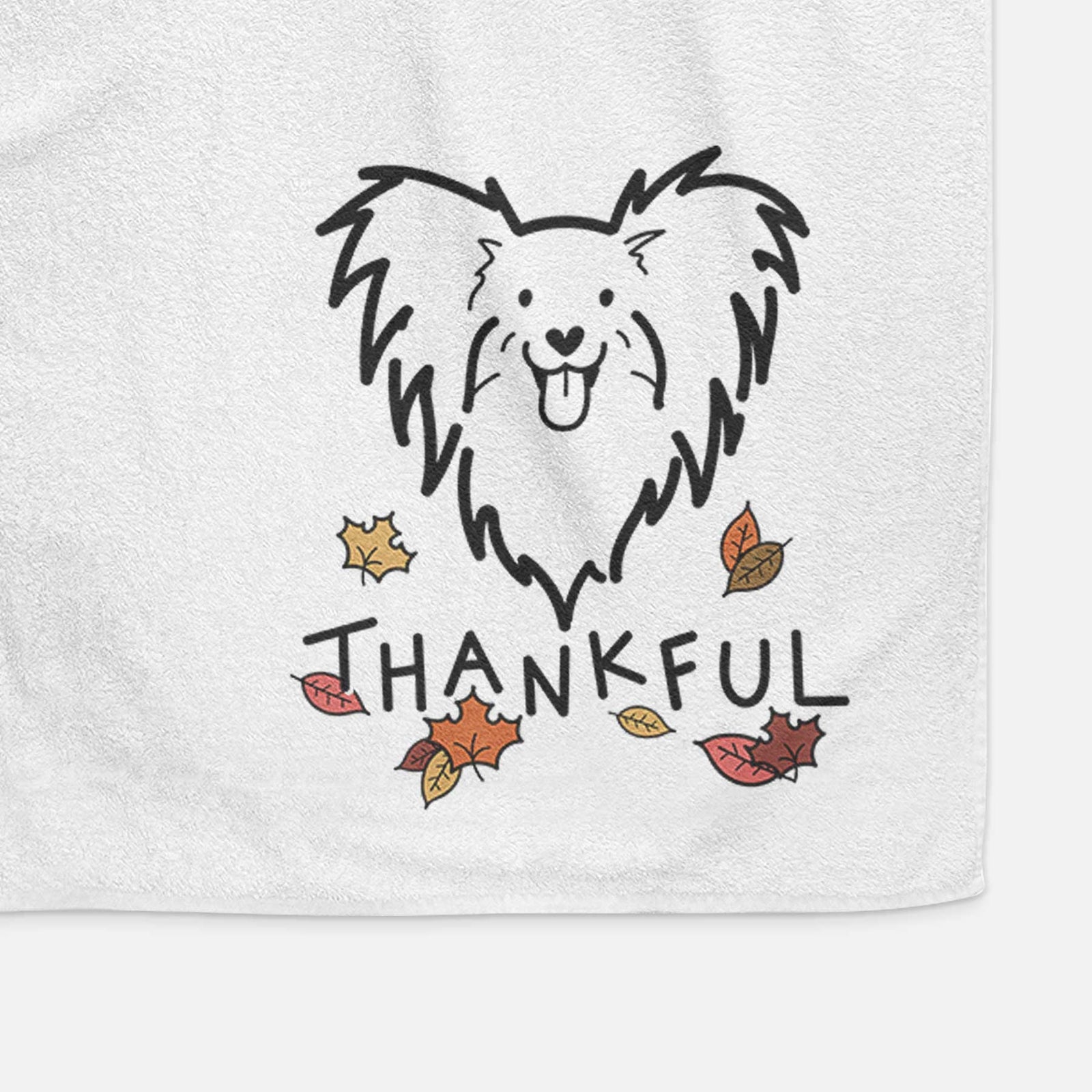 Minimalist line drawing of a Papillon with 'Thankful' lettering on a decorative hand towel