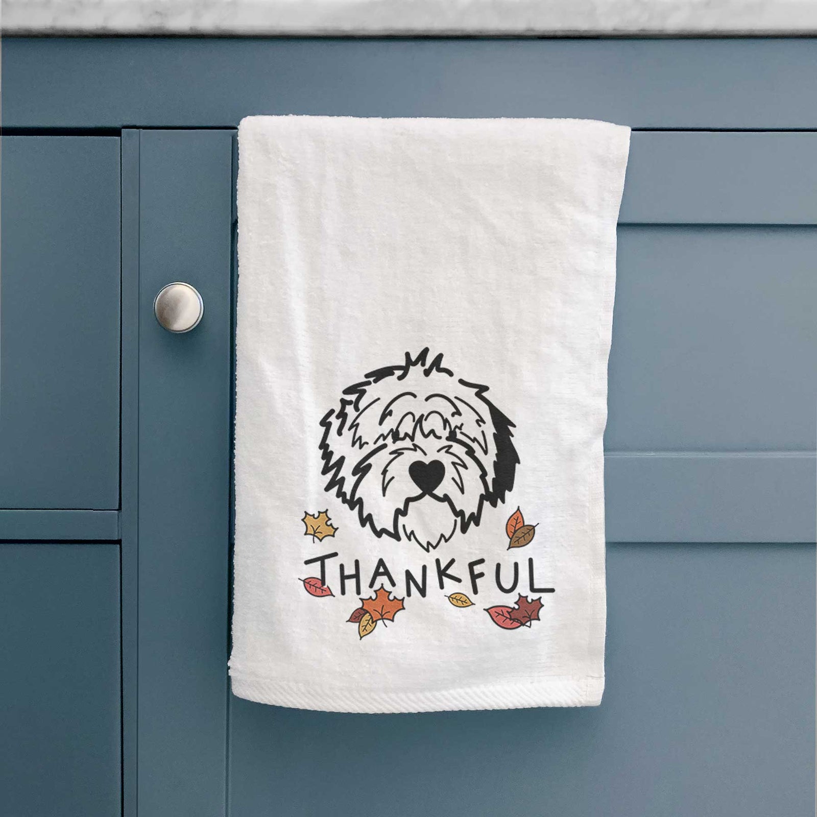 Minimalist line drawing of Penny the Old English Sheepdog with 'Thankful' lettering on a decorative hand towel