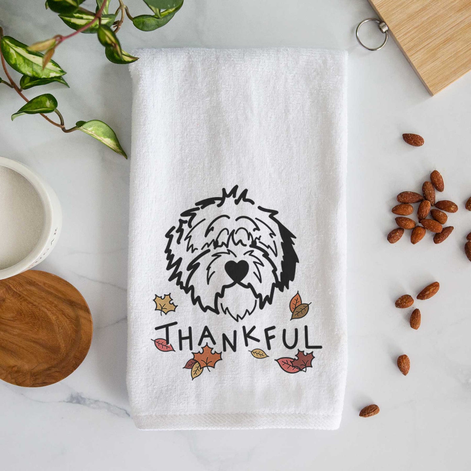 Minimalist line drawing of Penny the Old English Sheepdog with 'Thankful' lettering on a decorative hand towel