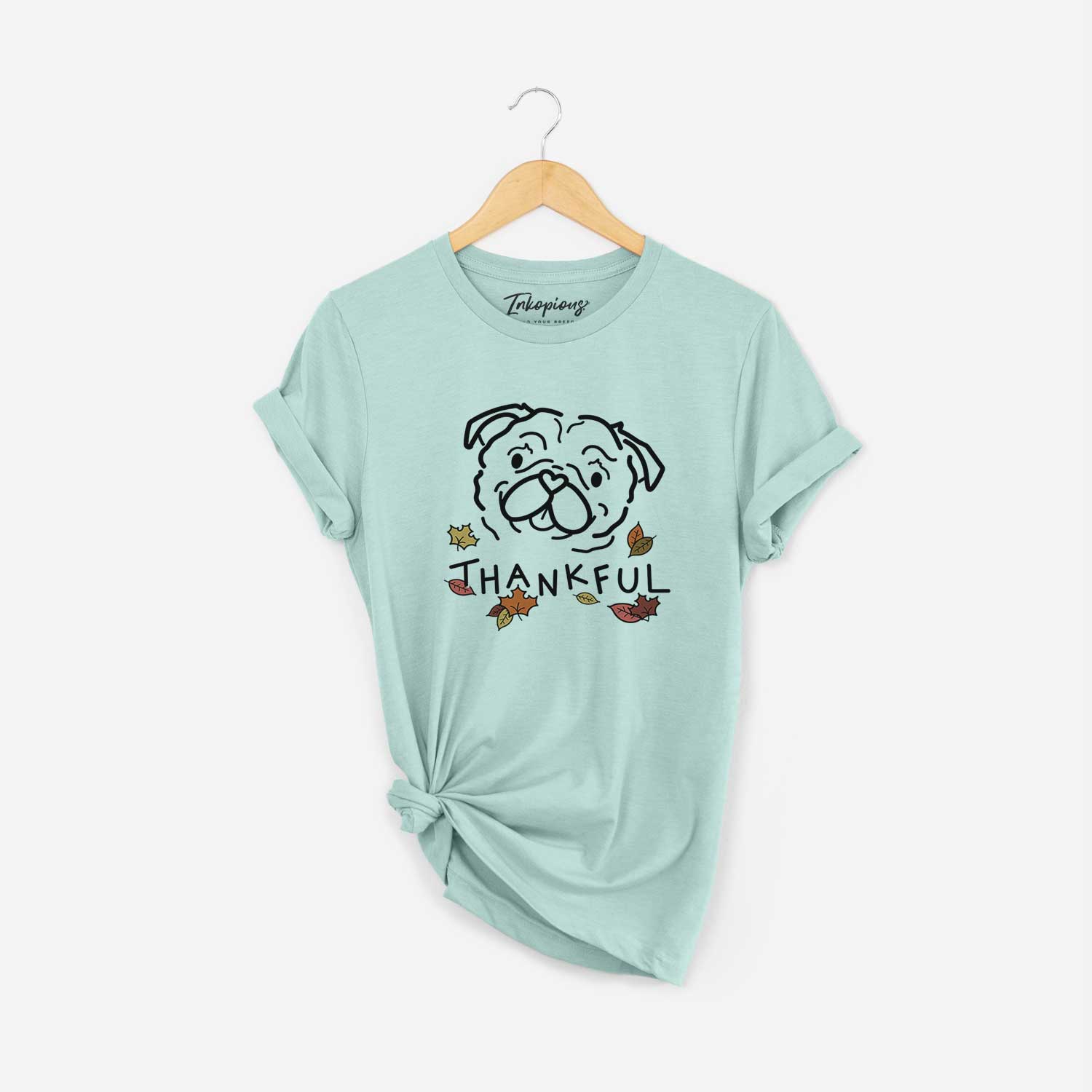 Minimalist line drawing of Pip the Pug with 'Thankful' lettering on a Heather Sage Unisex crewneck