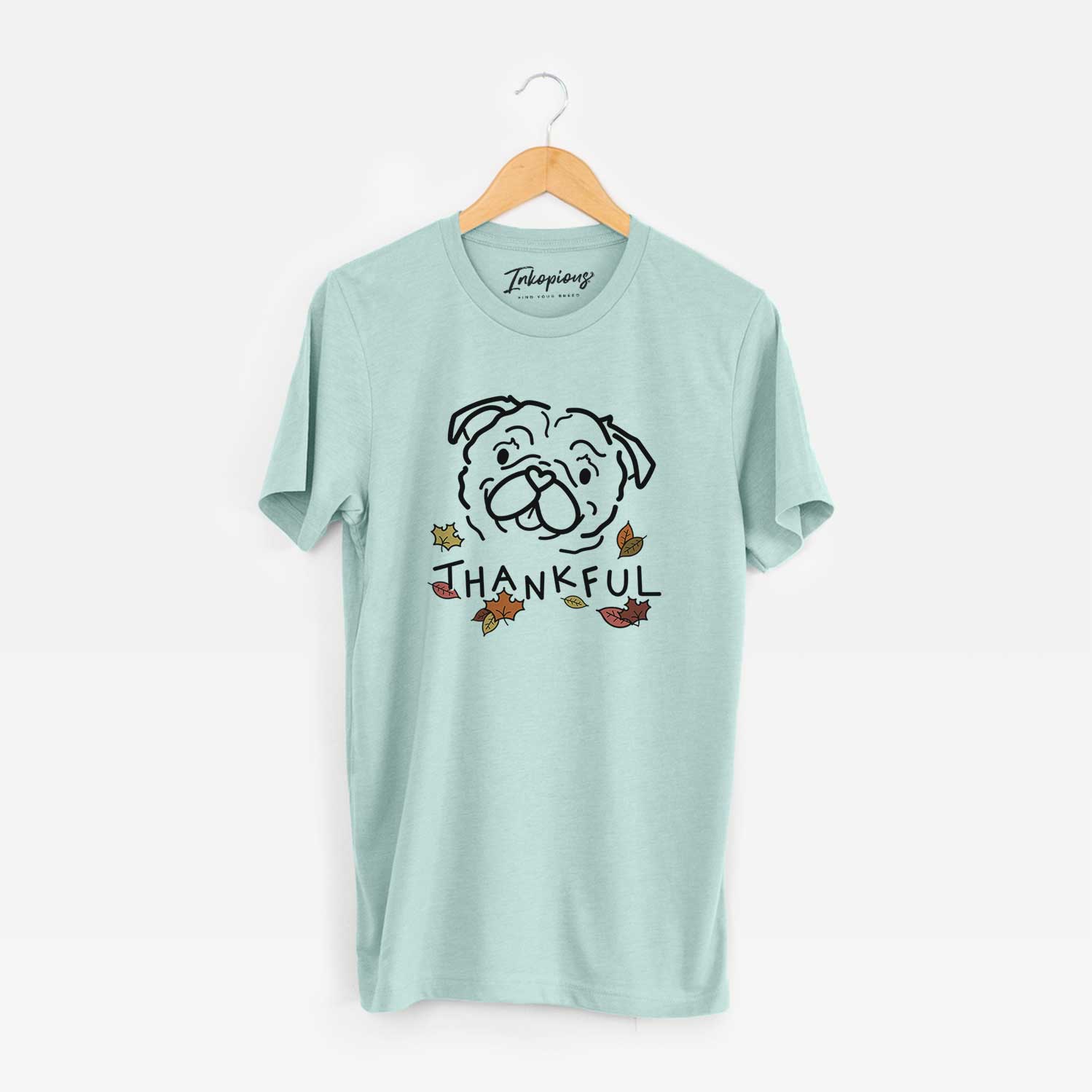 Minimalist line drawing of Pip the Pug with 'Thankful' lettering on a Heather Sage Unisex crewneck
