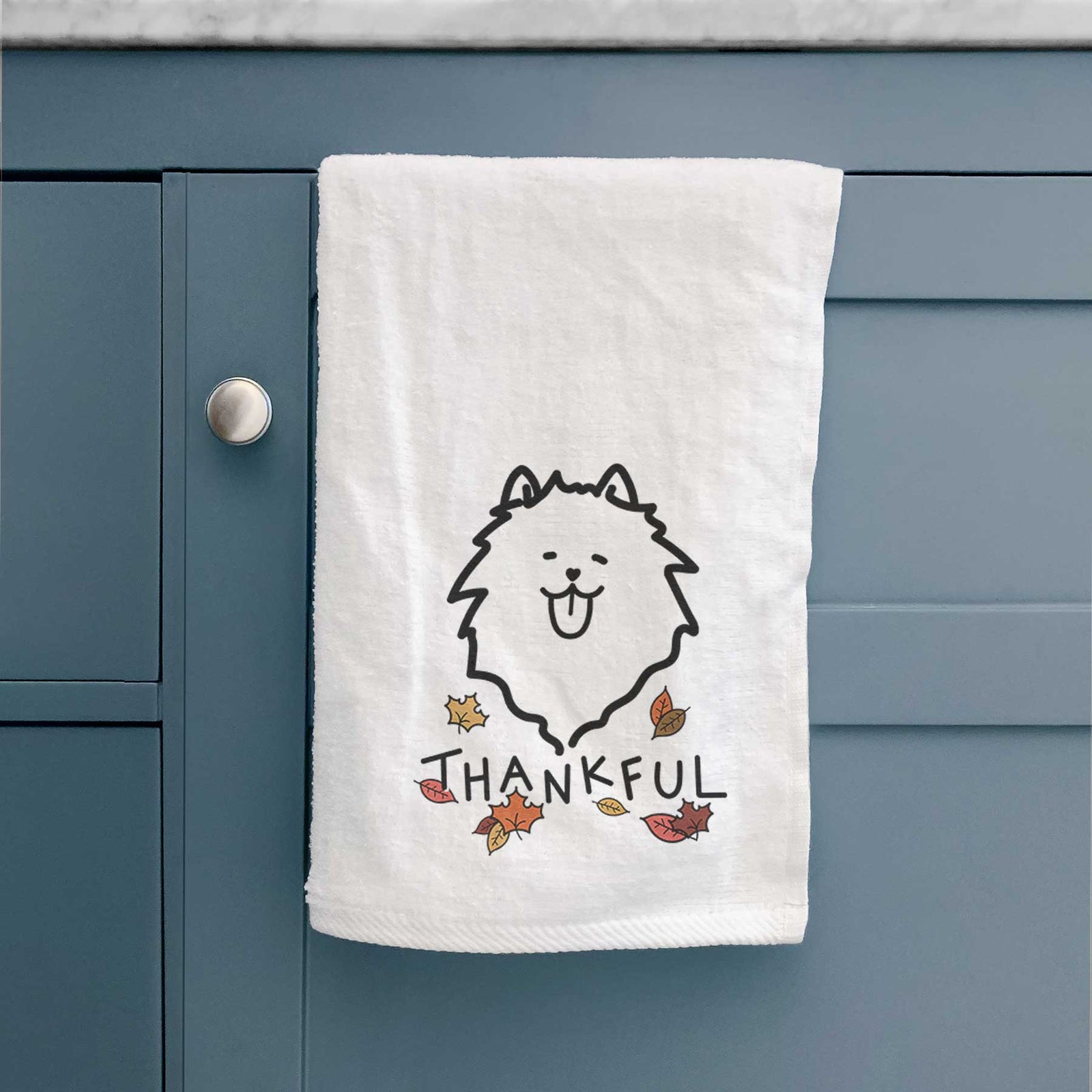 Minimalist line drawing of a Pomeranian with 'Thankful' lettering on a decorative hand towel